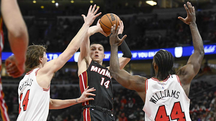 Feb 4, 2025; Chicago, Illinois, USA; Miami Heat guard Tyler Herro (14) passes the ball away from Chicago Bulls forward Matas Buzelis (14) and forward Patrick Williams (44) during the second half at United Center. Mandatory Credit: Matt Marton-Imagn Images Feb 4, 2025; Chicago, Illinois, USA; Miami Heat guard Tyler Herro (14) passes the ball away from Chicago Bulls forward Matas Buzelis (14) and forward Patrick Williams (44) during the second half at United Center. Mandatory Credit: Matt Marton-Imagn Images