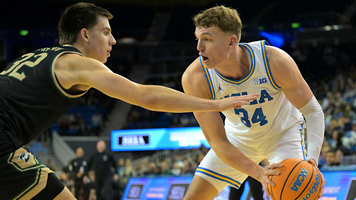 Nov 18, 2025; Los Angeles, California, USA;  UCLA Bruins forward Tyler Bilodeau (34) is defended by Sacramento State Hornets forward Mark Lavrenov (32) during the second half at Pauley Pavilion presented by Wescom Financial. Mandatory Credit: Jayne Kamin-Oncea-Imagn Images