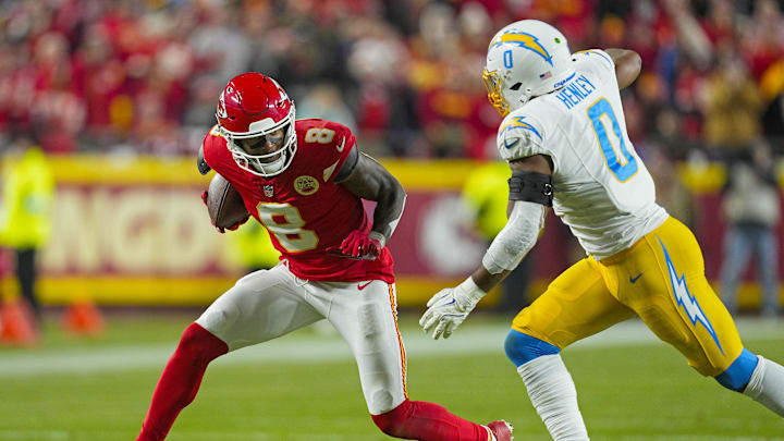 Dec 8, 2024; Kansas City, Missouri, USA; Kansas City Chiefs wide receiver DeAndre Hopkins (8) runs with the ball against Los Angeles Chargers linebacker Daiyan Henley (0) during the first half at GEHA Field at Arrowhead Stadium. Mandatory Credit: Jay Biggerstaff-Imagn Images