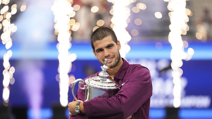 Spain's Carlos Alcaraz hugs the trophy after defeating Jannik Sinner  in the final of mens singles at the U.S. Open.