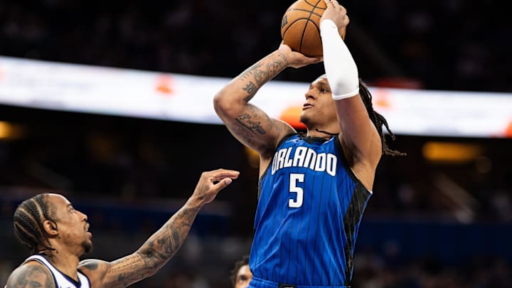 Mar 29, 2025; Orlando, Florida, USA; Orlando Magic forward Paolo Banchero (5) shoots the ball over Sacramento Kings guard Malik Monk (0) in the fourth quarter at Kia Center. Mandatory Credit: Jeremy Reper-Imagn Images