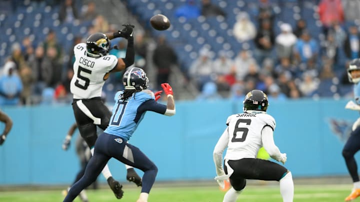 Dec 8, 2024; Nashville, Tennessee, USA;  Jacksonville Jaguars safety Andre Cisco (5) tips the forth down pass to Tennessee Titans wide receiver Calvin Ridley (0) during the second half at Nissan Stadium. Mandatory Credit: Steve Roberts-Imagn Images