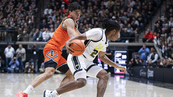 Jan 24, 2026; West Lafayette, Indiana, USA; Purdue Boilermakers guard Giacarri Harris (24) dribbles around Illinois Fighting Illini guard Andrej Stojakovic (2) during the first half at Mackey Arena. Mandatory Credit: Jacob Musselman-Imagn Images