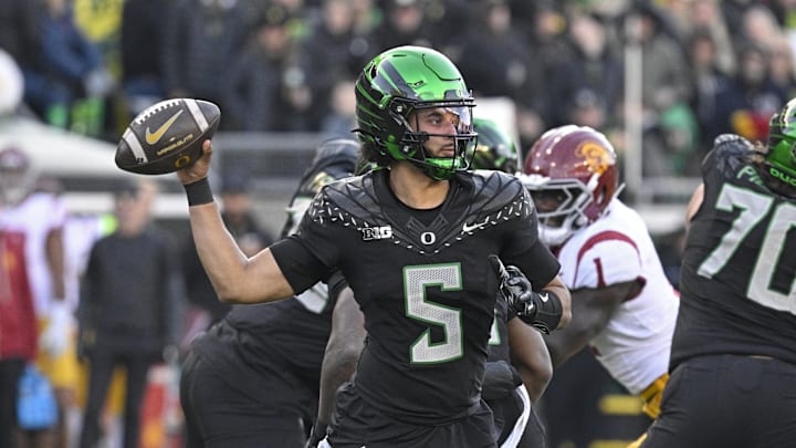 Nov 22, 2025; Eugene, Oregon, USA; Oregon Ducks quarterback Dante Moore (5) throws a pass against the Southern California Trojans during the second half at Autzen Stadium. Mandatory Credit: Troy Wayrynen-Imagn Images