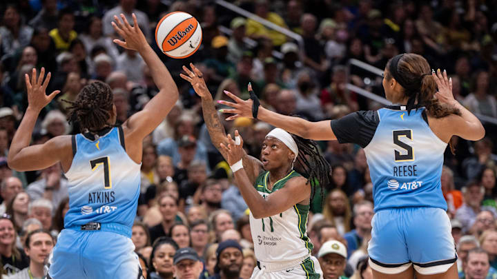 Aug 27, 2025; Seattle, Washington, USA; Seattle Storm guard Erica Wheeler (17) passes the ball against Chicago Sky guard Ariel Atkins (7) and forward Angel Reese (5) during the first half at T-Mobile Park. Mandatory Credit: Stephen Brashear-Imagn Images