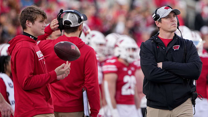 Nov 26, 2022; Madison, Wisconsin, USA; Wisconsin head coach Jim Leonhard, right, is shown during the first quarter of their game against Minnesota at Camp Randall Stadium. Mandatory Credit: Mark Hoffman-Imagn Images Nov 26, 2022; Madison, Wisconsin, USA; Wisconsin head coach Jim Leonhard, right, is shown during the first quarter of their game against Minnesota at Camp Randall Stadium. Mandatory Credit: Mark Hoffman-Imagn Images