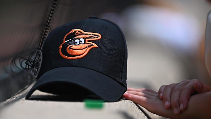 Jul 31, 2024; Baltimore, Maryland, USA; A Baltimore Orioles baseball cap of a fan before the game between the Baltimore Orioles and the Toronto Blue Jays at Oriole Park at Camden Yards. 