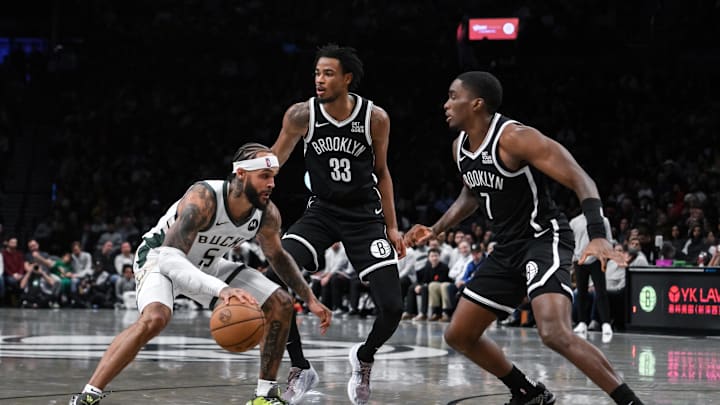 Dec 8, 2024; Brooklyn, New York, USA; Milwaukee Bucks guard Gary Trent Jr. (5) tries to get past Brooklyn Nets center Nic Claxton (33) and Brooklyn Nets guard Shake Milton (7) during the second half at Barclays Center. Mandatory Credit: John Jones-Imagn Images