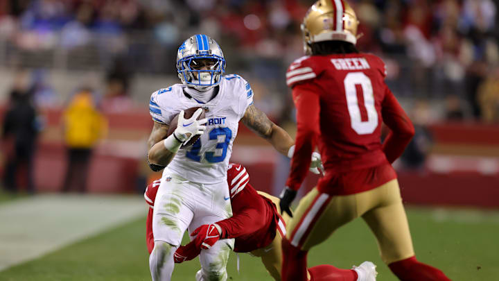 Dec 30, 2024; Santa Clara, California, USA; Detroit Lions running back Craig Reynolds (13) is tackled by San Francisco 49ers defensive tackle Sam Okuayinonu (91) during the third quarter at Levi's Stadium. Mandatory Credit: Sergio Estrada-Imagn Images