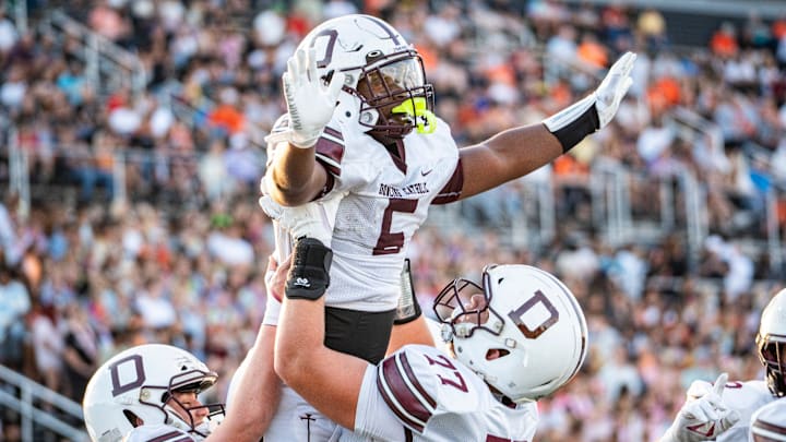 Dowling Catholic running back Ian Middleton (5) celebrates with offensive lineman Carter Barrett (77) during a high school football game between Valley and Dowling Catholic on Aug. 29, 2025, at Valley Stadium in West Des Moines, Iowa. Valley defeated Dowling Catholic 20-19.
