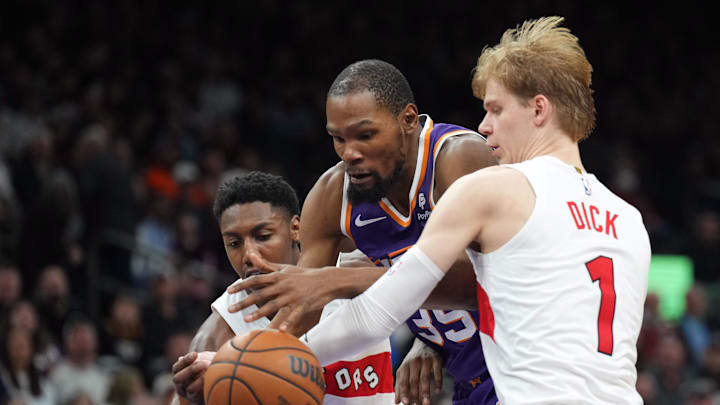 Mar 7, 2024; Phoenix, Arizona, USA; Phoenix Suns forward Kevin Durant (35) dribbles against Toronto Raptors guard RJ Barrett (9) and Toronto Raptors guard Gradey Dick (1) during the second half at Footprint Center. Mandatory Credit: Joe Camporeale-Imagn Images Mar 7, 2024; Phoenix, Arizona, USA; Phoenix Suns forward Kevin Durant (35) dribbles against Toronto Raptors guard RJ Barrett (9) and Toronto Raptors guard Gradey Dick (1) during the second half at Footprint Center. Mandatory Credit: Joe Camporeale-Imagn Images