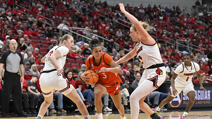 Jan 4, 2026; Louisville, Kentucky, USA;  Virginia Tech Hokies guard MacKenzie Nelson (3) drives to the basket against Louisville Cardinals forward Yevheniia Putra (12) and forward Laura Ziegler (0) during the second half at KFC Yum! Center. Louisville defeated Virginia Tech 85-60. Mandatory Credit: Jamie Rhodes-Imagn Images