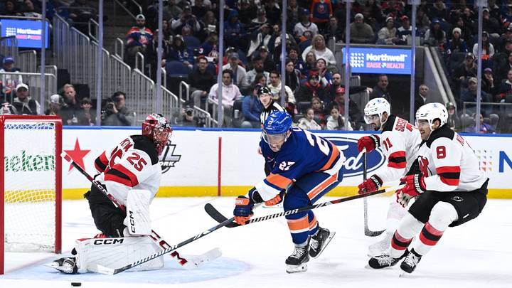 Nov 9, 2024; Elmont, New York, USA; New York Islanders left wing Anders Lee (27) shoots the puck as New Jersey Devils defenseman Jonas Siegenthaler (71), New Jersey Devils defenseman Johnathan Kovacevic (8) and New Jersey Devils goaltender Jacob Markstrom (25) defend during the second period at UBS Arena. Mandatory Credit: John Jones-Imagn Images Nov 9, 2024; Elmont, New York, USA; New York Islanders left wing Anders Lee (27) shoots the puck as New Jersey Devils defenseman Jonas Siegenthaler (71), New Jersey Devils defenseman Johnathan Kovacevic (8) and New Jersey Devils goaltender Jacob Markstrom (25) defend during the second period at UBS Arena. Mandatory Credit: John Jones-Imagn Images