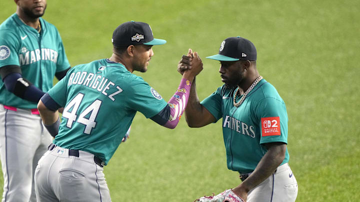 Oct 13, 2025; Toronto, Ontario, CAN; Seattle Mariners center fielder Julio Rodriguez (44) and left fielder Randy Arozarena (56) celebrate after defeating the Toronto Blue Jays in game two of the ALCS round for the 2025 MLB playoffs at Rogers Centre. Mandatory Credit: John E. Sokolowski-Imagn Images