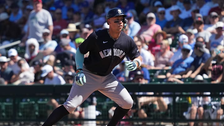 Mar 23, 2026; Mesa, Arizona, USA; New York Yankees right fielder Aaron Judge (99) hits a single against the Chicago Cubs in the fifth inning at Sloan Park. Mandatory Credit: Rick Scuteri-Imagn Images