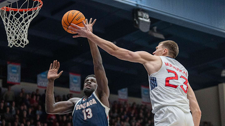 Feb 1, 2025; Moraga, California, USA;  St. Mary's Gaels forward Paulius Murauskas (23) shoots a layup against Gonzaga Bulldogs forward Graham Ike (13) during the first half at University Credit Union Pavilion.