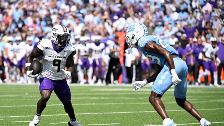 Sep 21, 2024; Chapel Hill, North Carolina, USA; James Madison Dukes wide receiver Omarion Dollison (9) with the ball as North Carolina Tar Heels defensive back Marcus Allen (29) defends in the first quarter at Kenan Memorial Stadium. Mandatory Credit: Bob Donnan-Imagn Images Sep 21, 2024; Chapel Hill, North Carolina, USA; James Madison Dukes wide receiver Omarion Dollison (9) with the ball as North Carolina Tar Heels defensive back Marcus Allen (29) defends in the first quarter at Kenan Memorial Stadium. Mandatory Credit: Bob Donnan-Imagn Images