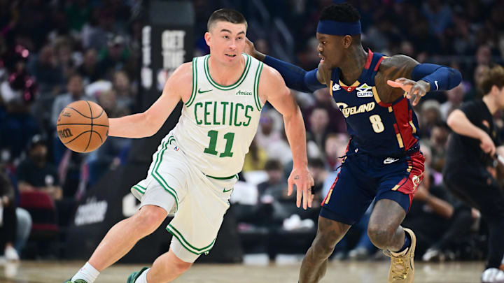 Mar 8, 2026; Cleveland, Ohio, USA; Boston Celtics guard Payton Pritchard (11) drives to the basket against Cleveland Cavaliers guard Dennis Schroder (8) during the first half at Rocket Arena. Mandatory Credit: Ken Blaze-Imagn Images