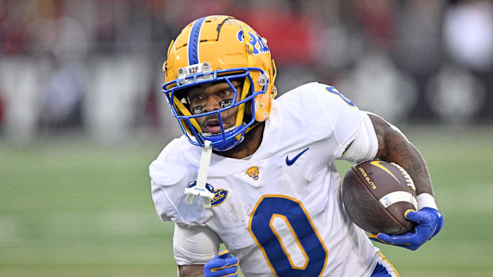 Nov 23, 2024; Louisville, Kentucky, USA;  Pittsburgh Panthers running back Desmond Reid (0) runs against the Louisville Cardinals during the first quarter at L&N Federal Credit Union Stadium. Mandatory Credit: Jamie Rhodes-Imagn Images