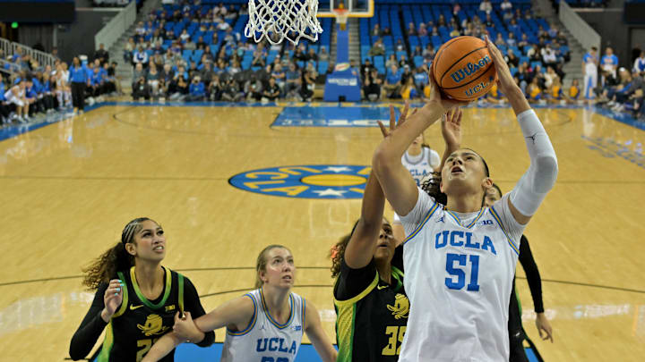 Dec 7, 2025; Los Angeles, California, USA;  UCLA Bruins center Lauren Betts (51) drives past Oregon Ducks forward Ehis Etute (35) for a basket during the first half at Pauley Pavilion presented by Wescom Financial. Mandatory Credit: Jayne Kamin-Oncea-Imagn Images