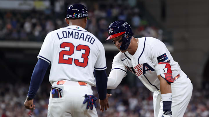 Mar 7, 2026; Houston, TX, United States; United States right fielder Aaron Judge (99) celebrates with first base coach George Lombard (23) after hitting an RBI single against Great Britain during the sixth inning at Daikin Park. Mandatory Credit: Troy Taormina-Imagn Images