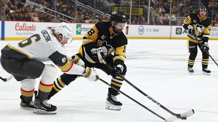 Mar 1, 2026; Pittsburgh, Pennsylvania, USA;  Pittsburgh Penguins center Tommy Novak (18) moves the puck against Vegas Golden Knights defenseman Kaedan Korczak (6) during the third period at PPG Paints Arena. Mandatory Credit: Charles LeClaire-Imagn Images