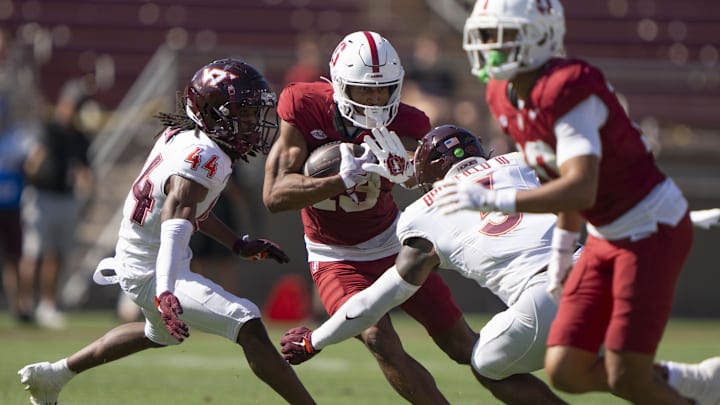 Oct 5, 2024; Stanford, California, USA; Stanford Cardinal wide receiver Elic Ayomanor (13) runs with the football against Virginia Tech Hokies cornerback Dorian Strong (44) and linebacker Sam Brumfield (3) during the third quarter at Stanford Stadium. Mandatory Credit: Stan Szeto-Imagn Images Oct 5, 2024; Stanford, California, USA; Stanford Cardinal wide receiver Elic Ayomanor (13) runs with the football against Virginia Tech Hokies cornerback Dorian Strong (44) and linebacker Sam Brumfield (3) during the third quarter at Stanford Stadium. Mandatory Credit: Stan Szeto-Imagn Images