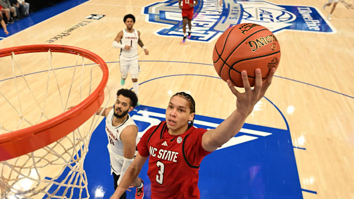 Mar 12, 2026; Charlotte, NC, USA; NC State Wolfpack guard Matt Able (3) scores as Virginia Cavaliers forward Devin Tillis (11) defends in the first half at Spectrum Center. Mandatory Credit: Bob Donnan-Imagn Images