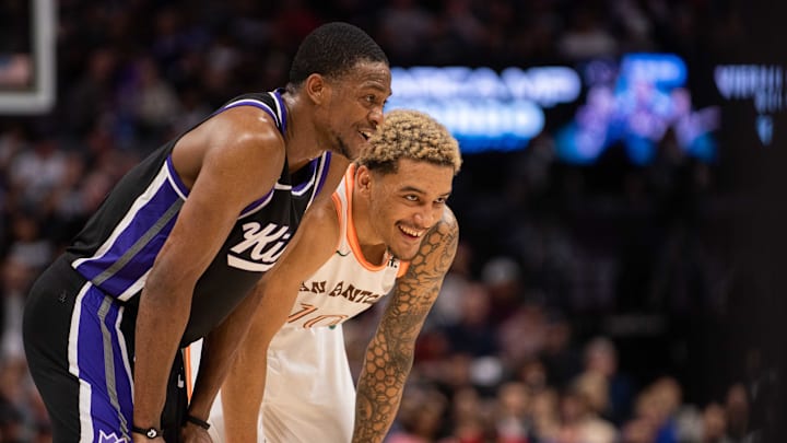 Feb 22, 2024; Sacramento, California, USA; Sacramento Kings guard De'Aaron Fox (5) and San Antonio Spurs forward Jeremy Sochan (10) smile during a free throw in the third quarter at Golden 1 Center. Mandatory Credit: Ed Szczepanski-Imagn Images