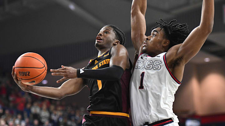 Nov 10, 2024; Spokane, Washington, USA; Arizona State Sun Devils guard Alston Mason, left, shoots the ball against Gonzaga Bulldogs guard Michael Ajayi (1) in the second half at McCarthey Athletic Center. Mandatory Credit: James Snook-Imagn Images