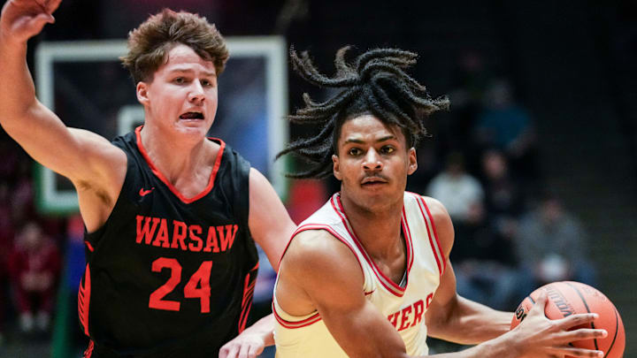 Fishers Tigers Jason Gardner (5) brings the ball up the court against Warsaw Tigers guard Carson Gould (24) on Saturday, Dec. 28, 2024, during the Boys Basketball Hall of Fame Classic at New Castle Fieldhouse.