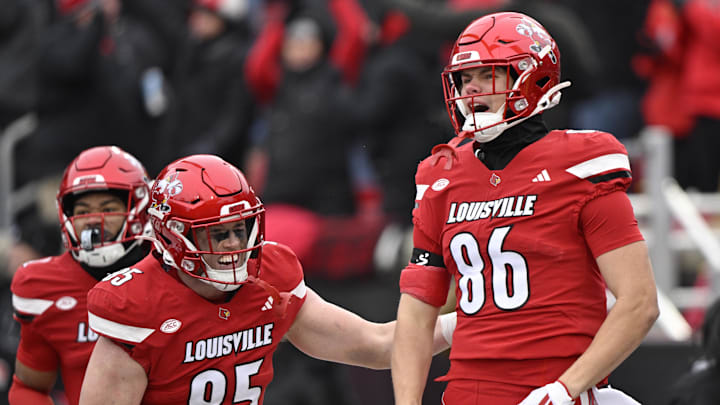 Nov 29, 2025; Louisville, Kentucky, USA;  Louisville Cardinals tight end Jacob Stewart (86) celebrates with tight end Nate Kurisky (85) after scoring a touchdown against the Kentucky Wildcats during the first half at L&N Federal Credit Union Stadium. Mandatory Credit: Jamie Rhodes-Imagn Images