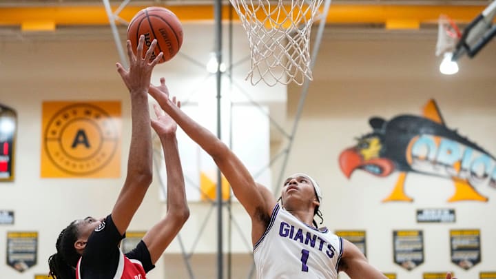 Ben Davis Giants Justin Parks (1) reaches for the ball against Pike Red Devils center Isaiah Hill (30) on Friday, March 7, 2025, during the IHSAA boys basketball sectional semifinal at Avon High School in Avon. Ben Davis defeated Pike with a close score of 43-41 to advance to the Sectional 11 final.