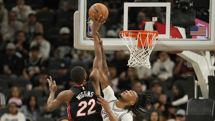 Oct 30, 2025; San Antonio, Texas, USA; San Antonio Spurs guard Stephon Castle (5) fouls Miami Heat forward Andrew Wiggins (22) during the first half at Frost Bank Center. Mandatory Credit: Scott Wachter-Imagn Images