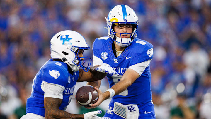 Sep 13, 2025; Lexington, Kentucky, USA; Kentucky Wildcats quarterback Cutter Boley (8) hands the ball off to running back Seth McGowan (3) during the first quarter against the Eastern Michigan Eagles at Kroger Field. Mandatory Credit: Jordan Prather-Imagn Images