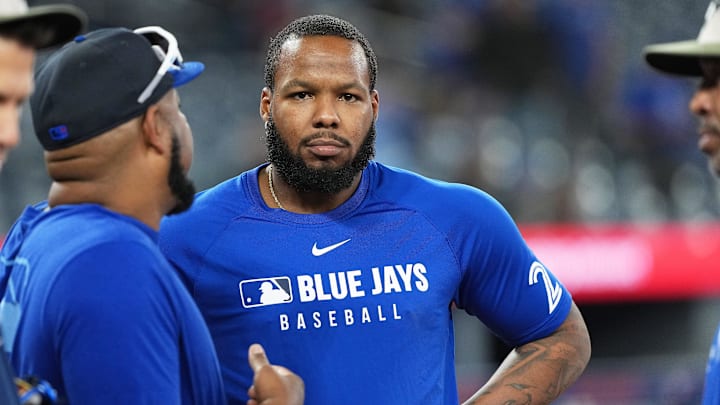 May 18, 2025; Toronto, Ontario, CAN; Toronto Blue Jays first baseman Vladimir Guerrero Jr. (27) talks with former player and assistant to the coaching staff Edwin Encarnacion during batting practice before a game against the Detroit Tigers at Rogers Centre. 