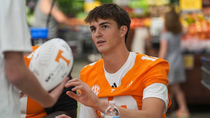 Tennessee quarterback George MacIntyre (12) reaches for a football to sign at a Tennessee Football meet and greet at Food City at 6710 Malone Creek Drive in Knoxville, Tenn., on July 25, 2026. Tennessee quarterback George MacIntyre (12) reaches for a football to sign at a Tennessee Football meet and greet at Food City at 6710 Malone Creek Drive in Knoxville, Tenn., on July 25, 2026.