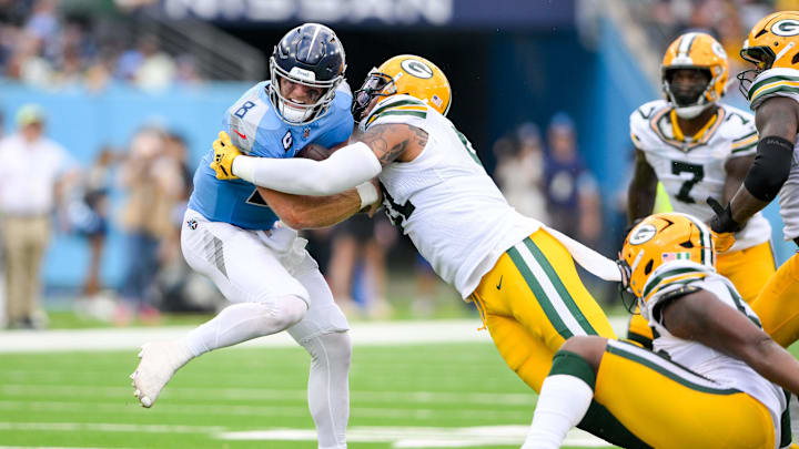 Sep 22, 2024; Nashville, Tennessee, USA;  Green Bay Packers defensive end Preston Smith (91) and defensive end Kingsley Enagbare (55) gets sacked Tennessee Titans Will Levis (8) during the second half at Nissan Stadium. Mandatory Credit: Steve Roberts-Imagn Images
