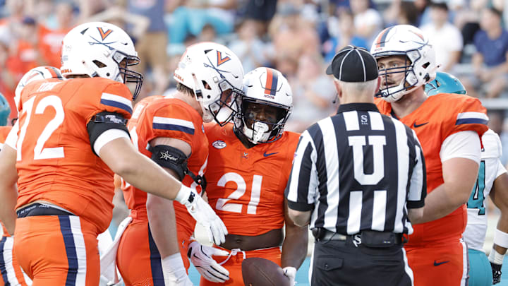 Aug 30, 2025; Charlottesville, Virginia, USA; Virginia Cavaliers running back Harrison Waylee (21) celebrates with teammates after scoring a touchdown against the Coastal Carolina Chanticleers during the second quarter at Scott Stadium. Mandatory Credit: Amber Searls-Imagn Images