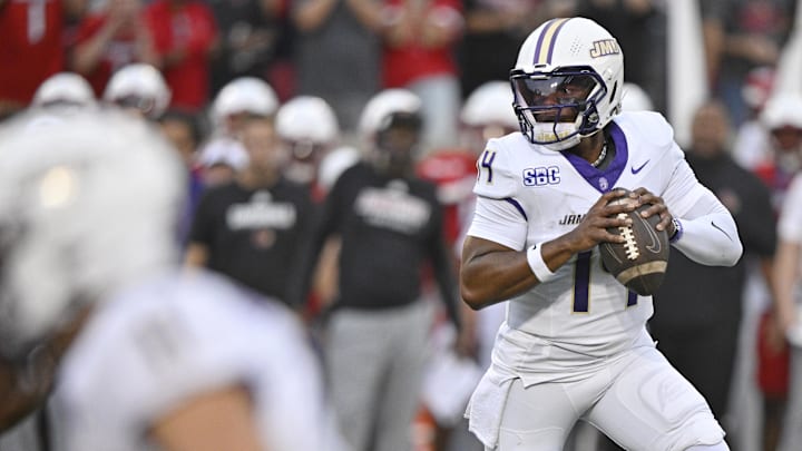 Louisville, Kentucky, USA;  James Madison Dukes quarterback Alonza Barnett III (14) looks to pass against the Louisville Cardinals during the first quarter at L&N Federal Credit Union Stadium.
