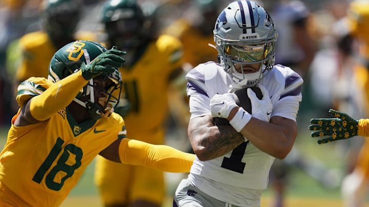 Oct 4, 2025; Waco, Texas, USA;  Kansas State Wildcats wide receiver Jayce Brown (1) protects the ball against Baylor Bears cornerback Caldra Williford (18) during the second half at McLane Stadium. Mandatory Credit: Chris Jones-Imagn Images