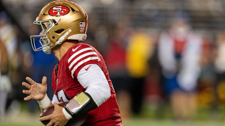 Oct 27, 2024; Santa Clara, California, USA; San Francisco 49ers quarterback Brock Purdy (13) runs for the first down during the second quarter against the Dallas Cowboys at Levi's Stadium. Mandatory Credit: Neville E. Guard-Imagn Images
