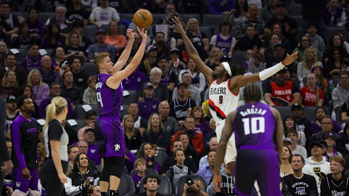 Oct 28, 2024; Sacramento, California, USA; Sacramento Kings guard Kevin Huerter (9) shoots the ball against Portland Trail Blazers forward Jerami Grant (9) during the first quarter at Golden 1 Center. Mandatory Credit: Sergio Estrada-Imagn Images