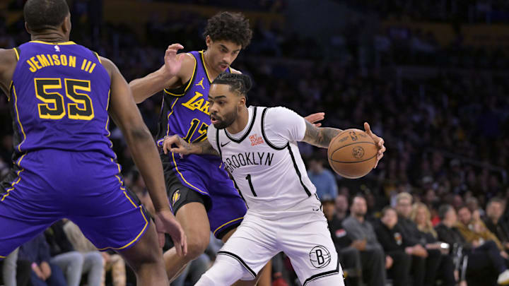 Jan 17, 2025; Los Angeles, California, USA; Brooklyn Nets guard D'Angelo Russell (1) drives past Los Angeles Lakers guard Max Christie (12) and center Trey Jemison III (55) in the first half at Crypto.com Arena. Mandatory Credit: Jayne Kamin-Oncea-Imagn Images Jan 17, 2025; Los Angeles, California, USA; Brooklyn Nets guard D'Angelo Russell (1) drives past Los Angeles Lakers guard Max Christie (12) and center Trey Jemison III (55) in the first half at Crypto.com Arena. Mandatory Credit: Jayne Kamin-Oncea-Imagn Images
