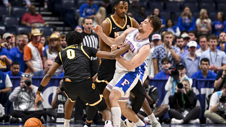 Mar 14, 2025; Nashville, TN, USA;  Florida Gators guard Walter Clayton Jr. (1) collides with Missouri Tigers center Josh Gray (33) during the first half at Bridgestone Arena. Mandatory Credit: Steve Roberts-Imagn Images