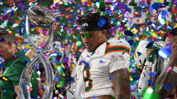 Dec 31, 2025; Arlington, TX, USA; Miami Hurricanes defensive back Jakobe Thomas (8) looks at the Cotton Bowl trophy after defeating the Ohio State Buckeyes during the 2025 Cotton Bowl and quarterfinal game of the College Football Playoff at AT&T Stadium. Mandatory Credit: Raymond Carlin III-Imagn Images