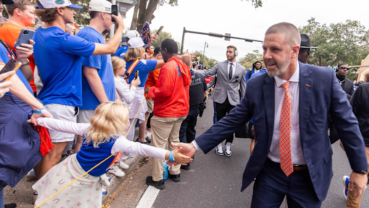 Florida Gators head coach Billy Napier shakes hands with fan after exiting the bus during Gator Walk before the game against the Kentucky Wildcats at Ben Hill Griffin Stadium in Gainesville, FL on Saturday, October 19, 2024. [Doug Engle/Gainesville Sun]
