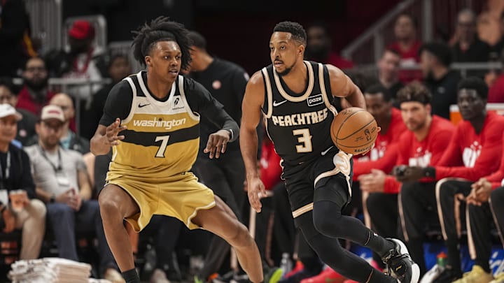 Feb 26, 2026; Atlanta, Georgia, USA; Atlanta Hawks guard CJ McCollum (3) dribbles against Washington Wizards guard Bub Carrington (7) during the first half at State Farm Arena. Mandatory Credit: Dale Zanine-Imagn Images