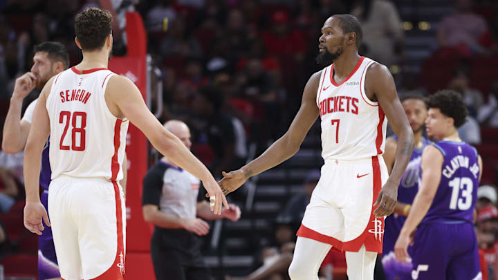 Oct 8, 2025; Houston, Texas, USA; Houston Rockets forward Kevin Durant (7) reacts with center Alperen Sengun (28) after a play during the second quarter against the Utah Jazz at Toyota Center. Mandatory Credit: Troy Taormina-Imagn Images