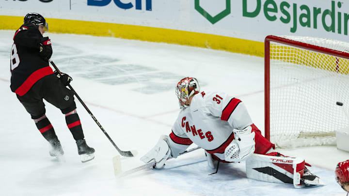 Apr 17, 2025; Ottawa, Ontario, CAN; Ottawa Senators center Tim Stutzle (18) scores against the Carolina Hurricanes goalie Frederik Andersen (31) in the third period at the Canadian Tire Centre. Mandatory Credit: Marc DesRosiers-Imagn Images